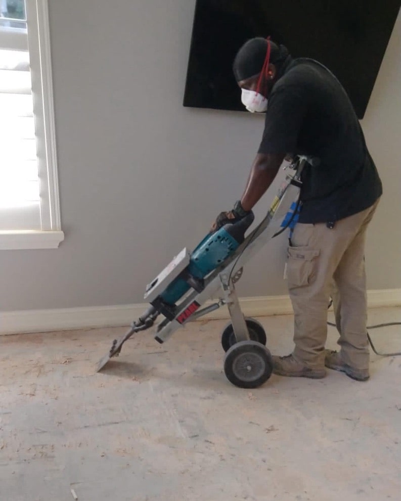 Professional cleaning a carpet before professional demolition and carpet removal services