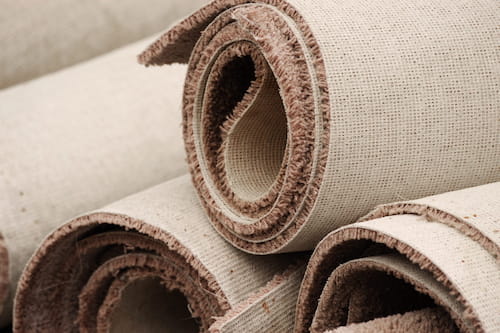 Old carpet rolls in need of carpet removal services